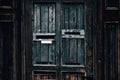 Old dark wooden door close-up of mail box Royalty Free Stock Photo