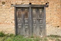 Old dark wooden doors in a stone building Royalty Free Stock Photo