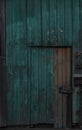 Old dark wooden rustic look barn doors. Metal hinges, and lock holders placed on the rough texture doors are very rusty Royalty Free Stock Photo