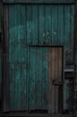 Old dark wooden rustic look barn doors. Metal hinges, and lock holders placed on the rough texture doors are very rusty Royalty Free Stock Photo