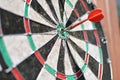Old dart board with arrow hitting a target. Royalty Free Stock Photo