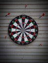 old dart board on wooden wall