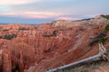 Old dead tree snag with aerial sunset view of hoodoo sandstone rock formations in Bryce Canyon National Park, Utah, USA Royalty Free Stock Photo