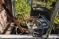 Old decayed cabin with control panel with steering wheel and knobs