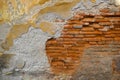 Old decomposed and shriveled brick wall. Abstract background texture of decay and decadence.