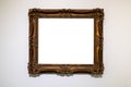 Old decorated wide dark picture frame on gray wall