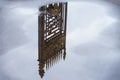 Old decorative iron fence reflected in puddle among the blue sky with clouds after rain. Concept dream, unreality Royalty Free Stock Photo