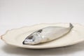 Old decorative presentationdish with tasty raw mackerel fish on table with an embroidered tablecloth