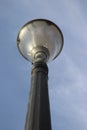 Old decorative streetlamp standing below the sky