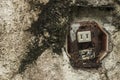 An old, defective and rusted outdoor two gang outlet on the concrete wall Royalty Free Stock Photo