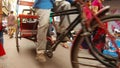 Old Delhi feet turn pedals of cycle rickshaws sellers citizen on narrow market street details