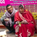 Old Delhi, India - December 9, 2019 : People sitting outside the temple for food and money at Old Delhi, Delhi Street Photography