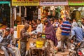 Street vendor pours cup hot tea Indian style