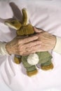 Old demented person with stuffed rabbit Royalty Free Stock Photo