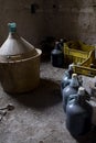 Old demijohm and wine flasks in an ancient cellar Royalty Free Stock Photo