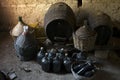 Old demijohns aged wine bottles and wooden barrels in a basement Royalty Free Stock Photo