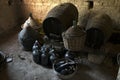 Old demijohns aged wine bottles and wooden barrels in a basement Royalty Free Stock Photo