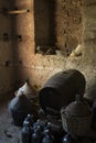 Old demijohns aged wine bottles and wooden barrels in a basement Royalty Free Stock Photo