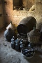 Old demijohns aged wine bottles and wooden barrels in a basement Royalty Free Stock Photo