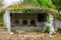 Old demolished building with the roof covered in grass and plants Royalty Free Stock Photo