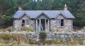 An old derelict and abandoned stone Victorian Style Cottage beside Loch Lee in the Forests of Glen Esk in the Angus Glens.