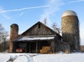 Old derelict ag barn with silos and old truck in FingerLakes winter Royalty Free Stock Photo