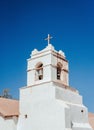 Old, derelict building with a large cross at the top