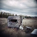 Old derelict caravan sitting abandoned in a rural paddock