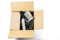 Old desk phones in a cardboard box isolated on a white