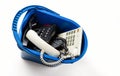 Old desk phones in a trash can isolated on a white