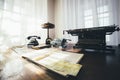 Old desk with a typewriter and vintage phone Royalty Free Stock Photo