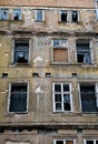 Old Desolate Apartment House With Damaged Facade And Bursted Windows