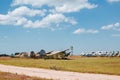 Old destroyed abandoned airplanes and helicopters in the field, cemetery of old helicopters and planes