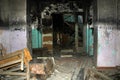 An old destroyed and charred building from the inside with the remains of things