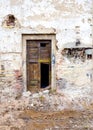Old and destroyed door of damaged building Royalty Free Stock Photo