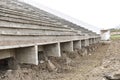 Old destroyed grandstands at stadium under construction