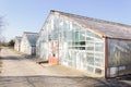 Old destroyed greenhouses with broken glassand rust on the frame and door. Urban ruined geometry. Royalty Free Stock Photo