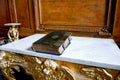 Old destroyed leather bound Bible lying on the altar Royalty Free Stock Photo