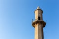 Old destroyed sandstone minaret of a mosque against crystal blue sky background in Al Jazirah Al Hamra, UAE Royalty Free Stock Photo