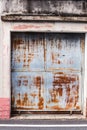 Old detailed aged vintage rusty red brown textured zinc alloy metal sheet exterior fence door used in construction industry as Royalty Free Stock Photo