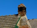 rural meat smoking building with old brick chimney and black soot