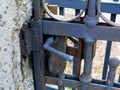 Deteriorating grunge wrought iron gate detail with lock