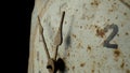 Old dial with rusty weathered hour and minute hands and numerals. White face of vintage clock with rust and dirt on Royalty Free Stock Photo