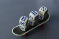 Old dice and finger skate on a gray background Royalty Free Stock Photo