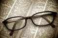 Old dictionary and black glasses Royalty Free Stock Photo