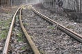 Old, dilapidated and abandoned railway station with rusty railway tracks and wooden railway sleepers Royalty Free Stock Photo