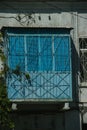 Old dilapidated balcony in blue in an old residential building, closeup Royalty Free Stock Photo