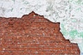 Old dilapidated brick wall, crumbling plaster