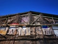 Old dilapidated house facade and blue sky Royalty Free Stock Photo