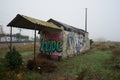 old and dilapidated house of the guard railway lines with the word hope painted on the wall.